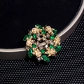 Elegant gold wreath brooch with emerald green stones and shimmering rhinestones - Green Crystal Garland