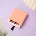 Pink square drawer jewelry box with black ribbon pull on a light purple background - Elegant Pink Drawer + Pink Box / Round Base