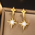 Macro shot of gold North Star earrings with white shell inlay on a jewelry box - Gold E-397 (White North Star)