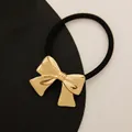 Elegant gold metal bow hair tie with a black elastic band for minimalist ponytail styles - Ribbon Bow