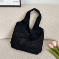Detailed view of black lace butterfly embroidery on a large capacity cotton tote bag - Black