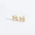 Elegant gold bow earrings encrusted with sparkling white zircons on a white background - Bow