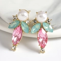 Luxurious geometric teardrop earrings with pink jewels and pearls on marble display - Green and Pink