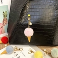 Detailed view of cute faux fur ice cream cone keychain featuring pearl and golden clip. - Single Piece / Pink