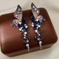 Macro shot of colorful zircon butterfly wing tassel earrings on a brown jewelry box - Silver Needle-Blue-Purple