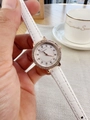 Detail of rose gold rhinestone watch with white leather strap and quilted dial pattern - White