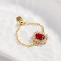 Macro detail of adjustable gold chain ring with square red gemstone and heart charm - Red Zirconia - Gold