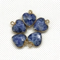 Macro view of blue heart stone pendants with gold bezels on a white textured background - 15x18mm / Blue Spot Stone