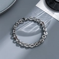 Macro view of interlocking silver stainless steel chain bracelet with industrial finish - gf62-Heavy Industrial Style