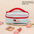 Light blue quilted makeup bag with red handles and milo bliss label in size 24x14x9cm - Light Blue Quilted Handbag