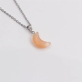 Gros plan détaillé d'un pendentif lune en pierre œil de chat orange sur chaîne argent - Orange