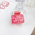 Pink heart patterned hair claw clip with Cupid's arrow design on a white surface - Heartbeat Moment - Square