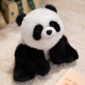 Realistic giant panda plush toy with soft black and white fur on a cozy carpet - Panda