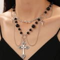 Gothic multi-layer necklace with punk metal cross and star pendants on a model - Gothic Black Bead Cross Layered Style