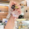 Swan wind chime keychain with purple sequins and dried flowers in a liquid sphere - Oil-filled Flower - White