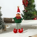 Dettaglio di un elfo di Natale in paillettes verdi seduto su una panca bianca - Elfo Verde con Gambe Lunghe