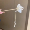 Close-up of golden hair stick with white fabric petals, pearls, and long tassels - F0736 Mesh Flower