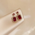 Elegant gold-framed ruby earrings with rectangular cut stones and pavé zircon accents - Red Stud Earrings (Gold)
