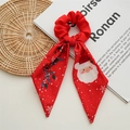 Detail of red Christmas scrunchie with Santa Claus pattern and ribbon on white background - Red Snowman