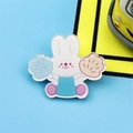 Cute white acrylic bunny badge pin with blue clothes and colorful pompom accents - Lala Rabbit