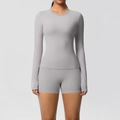 Close-up of slim-fit yoga set featuring a light grey round neck top and high-stretch shorts - Frost Grey