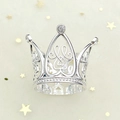 Close-up of silver crown with hollow heart design and sparkling crystals on star background - Heart Finger Small Silver 01
