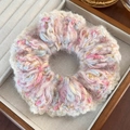 Detailed view of a soft knit scrunchie with pink and blue yarn in a velvet jewelry box - Plush Knit Mixed Color Style