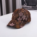 Close-up of vintage lace embroidery with golden leaves and pink floral details on the cap - One Size / Brown
