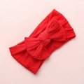 Detailed close-up of red cable-knit texture and large bow on a nylon baby headband - Red