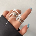 Minimalist silver interlocking crossover ring with polished finish on model hand - Smooth Croissant/Triple Layer Intertwined