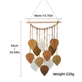 Bohemian woven leaf wall hanging in white, ginger, and coffee colors on wood - Brown