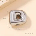 Macro shot of polished 3D bubble letter D pendant with dimensions 1.9cm by 2.2cm - Silver/Steel (D) (Large)