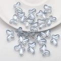 Macro shot of 10x14mm translucent grey-blue butterfly glass beads for DIY jewelry making - Light Blue Grey
