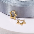 Macro detail of minimalist gold star hoop earrings on a luxury grey silk fabric background - 18K Gold Plated / Pentagram / Gold