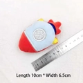 Detailed view of a 10x6.5cm plush rocket keychain with ruler showing actual product size - Rocket