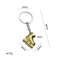 Portachiavi a forma di pattino a rotelle in metallo dorato con misure e dettagli tecnici - Oro X-959
