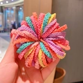 Hand holding a bulk set of seamless pastel candy color wavy hair ties in soft fabric - Spring Colors