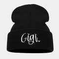 Close-up of Gigi script embroidery on a black knit beanie with premium ribbed texture - One Size / Black