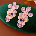 Detail van handgemaakte roze kanten bloemenoorbellen met pailletten op groen fluweel - Zilveren oorknopje-Blauw / Blauw