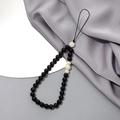 Close-up of elegant polished black and white crystal beaded phone chain with durable loop - Phone Chain / Black Striped Stone + White Jade Bodhi (K3403)