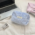 Detail shot of light blue leopard faux fur pouch with side strap and brand label - Blue