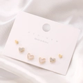 Detailed view of three pairs of gold and enamel heart stud earrings on a display card - 94 KC Gold (9235)