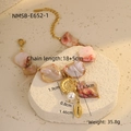 Macro shot of ocean style stainless steel bracelet with shells and pink pearl beads - Pink Conch Bracelet