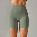 Detail of high-waist sage green yoga shorts with seamless hem and soft brushed fabric - Light Grass Green