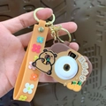 Brown Capybara camera keychain with orange floral wrist strap and golden ring - Capybara - Camera Style