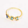 Close-up of gold ring set with three blue rectangular stones and white zircons - US 6 / Three Zirconia