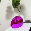 Close-up of egg-shaped purple mirror evening bag with metallic finish and metal clasp - Purple (Lined)