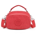 Red nylon crossbody cell phone bag with detachable strap and circular logo detail - Rose