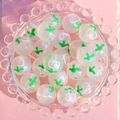 Close-up of 16mm luminous starry beads with pink tulips and glitter inside a glass bowl - Tulip / 16mm Luminous
