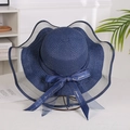 Detail of dark blue straw sun hat featuring wave organza brim and bow with gold lettering - Mesh Edge Navy Blue